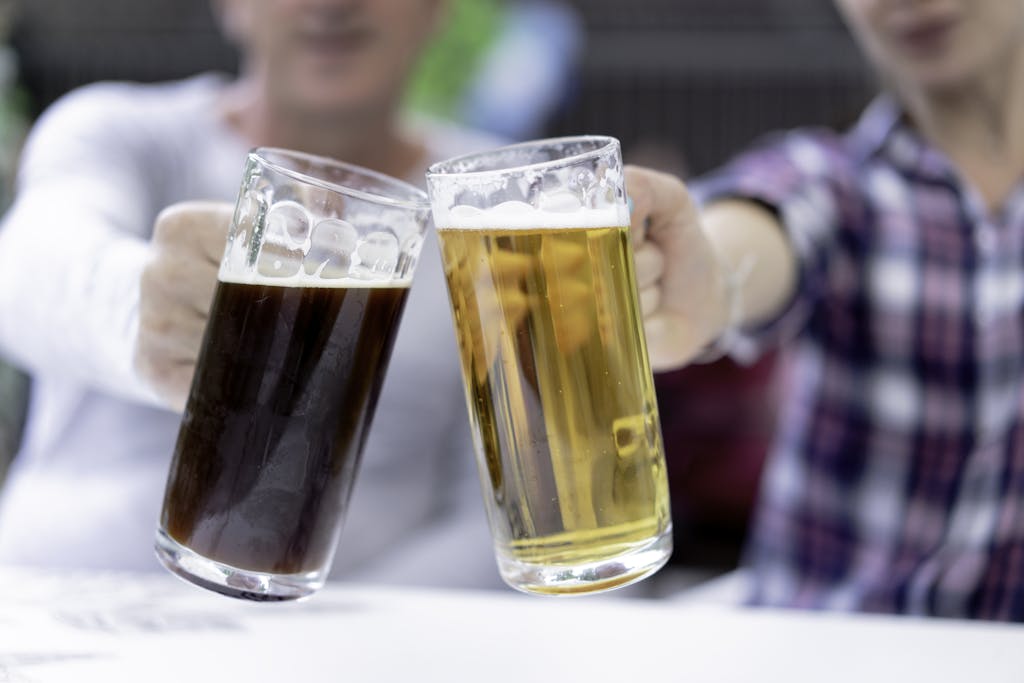 Men Holding Glass Beer Steins